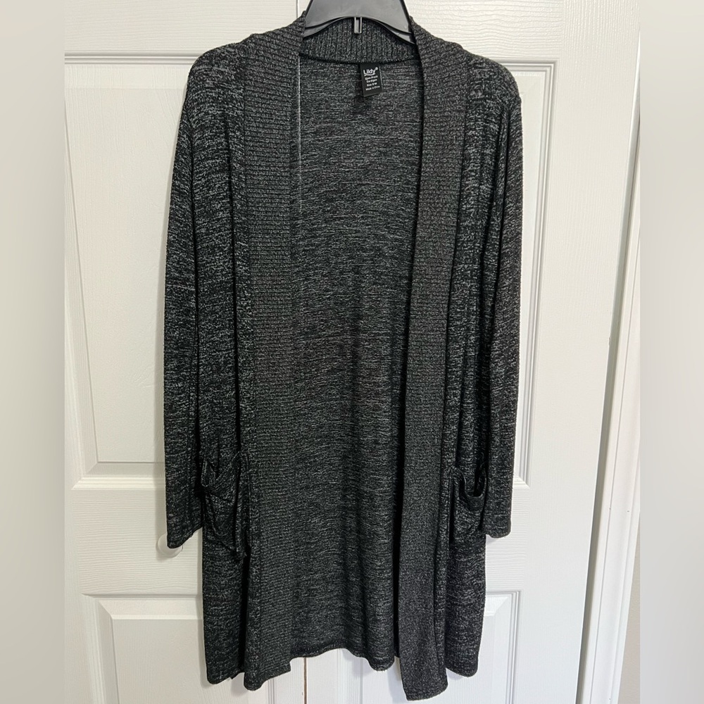 Cardigan is black in color. Size S-M. Has pockets and long sleeves.